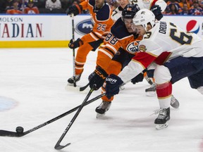 Brandon Davidson, left, of the Edmonton Oilers tries to defend against Evgenil Dadonov of the Florida Panthers during NHL action Monday at Rogers Place. Dadonov had a pair of goals in a 7-5 Florida win.