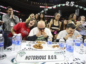 FILE - In this Friday, Feb. 3, 2017 file photo, Bob "Notorious B.O.B." Shoudt, left, takes part in the Wing Bowl in Philadelphia. Thousands of Philadelphia Eagles fans will be heading to a sports arena for a popular contest started years ago to make up for the fact their team was unlikely to appear in the Super Bowl. Only this year, Philadelphia will be in the big game so the chicken wing-eating competition known as the Wing Bowl also will be a rally for the Eagles. Wing Bowl 26 takes place Friday, Feb. 2, 2018 at the Wells Fargo Center and is expected to draw nearly 20,000 spectators.