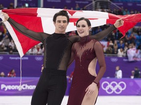 Ice dance gold medalists Canada's Tessa Virtue and Scott Moir skate with the Canadian flag during victory ceremonies at the Pyeongchang Winter Olympics Tuesday, February 20, 2018 in Gangneung, South Korea.