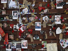 FILE-In this Oct. 16, 2017, file photo,,photos and notes adorn a wall at the Las Vegas Community Healing Garden in Las Vegas. The garden was built as a memorial for the victims of the recent mass shooting in Las Vegas. Two Nevada judges in Las Vegas have ordered the release of search warrant records and autopsy reports related to the deadliest mass shooting in modern U.S. history, with some information redacted.