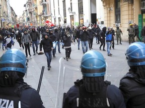 Activists clash with police during a protest on the occasion of an electoral rally of the League party's leader, Matteo Salvini, in Pisa, Italy, Friday, Feb. 23, 2018. Italy's general elections are scheduled for March 4, 2018.