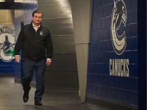 Vancouver Canucks GM Jim Benning walks inside Rogers Arena on Feb. 26.