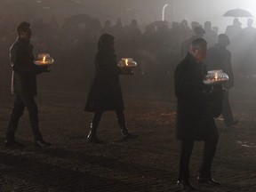 Survivors of Auschwitz arrive at the International Monument to the Victims of Fascism at the former Nazi German concentration and extermination camp KL Auschwitz II-Birkenau walk to place candles on International Holocaust Remembrance Day in Oswiecim, Poland, Saturday, Jan. 27, 2018.