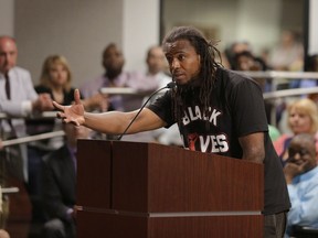 In this April 9, 2015 file photo, Muhiyidin Moye speaks during a meeting with North Charleston city council about the killing of Walter Scott by a North Charleston police officer after a traffic stop in North Charleston, S.C.