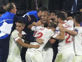 FILE - In this Nov. 21, 2017 file photo, Sevilla players celebrate after Guido Pizarro, center, scored their third goal during a Champions League group E soccer match between Sevilla and Liverpool, at the Ramon Sanchez Pizjuan stadium in Seville, Spain. Sevilla has won three in a row entering the first leg of a round of 16 Champions League match against Manchester United at home, on Wednesday Feb. 21, 2018 but coach Vincenzo Montella is far from happy with how his team has performed in attack.