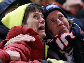 Sue Sweeney, left, the mother of Emily Sweeney of the United States, cries out as her daughter crashes on the final run during the women's luge final at the 2018 Winter Olympics in Pyeongchang, South Korea, Tuesday, Feb. 13, 2018.