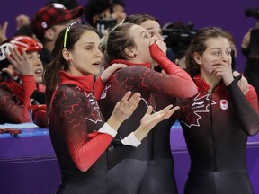 Canadian skaters react after being disqualified from their women's short-track speed skating 3000-metre  relay final on Tuesday, Feb. 20, 2018.