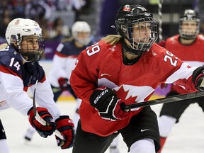 In this Feb. 20, 2014 file photo, Canadian forward Marie-Philip Poulin (right) skates against the U.S. in the gold-medal game at the Sochi Olympics.