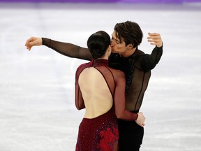 Tessa Virtue and Scott Moir share a moment after their routine in the Team Event Ice Dance Free Dance program in the Gangneung Ice Arena on Feb. 12, 2018