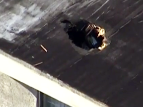 Damage after a life raft from a RCAF Griffon helicopter fell onto a house in Miami, punching a hole in the roof.