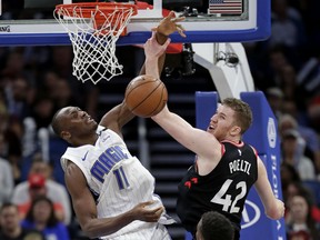 The Magic's Bismack Biyombo and Jakob Poeltl of the Toronto Raptors compete for a rebound during the second half of their game Wednesday night, in Orlando, Fla. Toronto won 117-104.