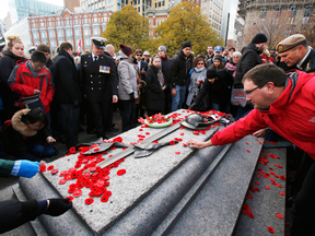 Members of the public lay poppies at the Tomb of the Unknown Soldier during Remembrance Day ceremonies in Ottawa.