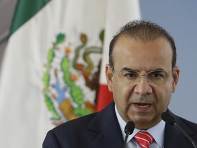 Mexico's Interior Secretary Alfonso Navarrete speaks during the groundbreaking ceremony for the new U.S. embassy, in Mexico City, Tuesday, Feb. 13, 2018. Navarrete told local media that the federal intelligence agency sent a plainclothes agent to tail an opposition presidential candidate, even though the candidate never asked for and apparently did not want a tail.