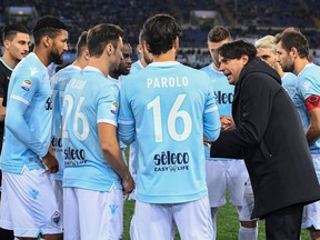 Lazio's coach Simone Inzaghi talks to his team's players prior the Italian Serie A soccer match between Lazio and Verona at the Olympic stadium in Rome, Italy, Monday, Feb. 19, 2016.