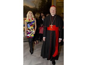 Cardinal Gianfranco Ravasi and designer Donatella Versace arrive at Palazzo Colonna in Rome, Monday, Feb. 26, 2018.  The Vatican is loaning some of its most beautiful liturgical vestments, jeweled miter caps and historic papal tiaras for an upcoming exhibit on Catholic influences in fashion at the Metropolitan Museum of Art. The Vatican culture minister, Cardinal Gianfranco Ravasi, joined Vogue Editor-in-Chief Anna Wintour and designer Donatella Versace in Rome on Monday to display a few of the Vatican treasures at the Palazzo Colonna, a onetime papal residence. "Heavenly Bodies: Fashion and the Catholic Imagination" is set to open May 10 at the Met's Costume Institute in New York.