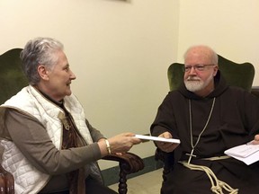 Marie Collins, a member of the pope's sex-abuse commission, hands a letter to Cardinal Sean O'Malley detailing the abuse of Juan Carlos Cruz and a cover-up by Chilean church authorities, at the Domus Santa Marta on April 12, 2015. Commission members and Cruz say O'Malley later confirmed he gave the letter to Pope Francis, contradicting the pope's recent insistence that no victims had come forward.