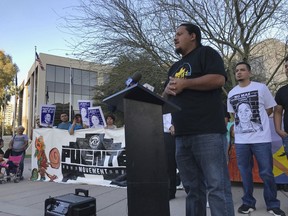 Carlos Garcia, executive director of the immigrant advocate group Puente, addresses a rally of some 40 people outside the U.S. Immigration and Customs Enforcement building in Phoenix, Monday, Feb. 5, 2018. A year ago, immigrant mother Guadalupe Garcia de Rayos was arrested and deported back to her native Mexico. Her case became a cause celebre for advocates who say President Donald Trump's immigration policies hurt families. Her attorney is seeking to reopen her case for using a fraudulent ID to get a job, a conviction that made her vulnerable to deportation under Trump after enjoying leniency during the Obama administration.