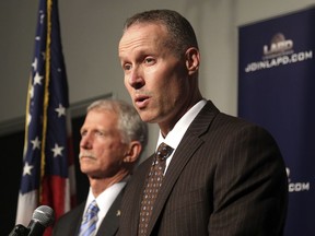 Justin Eisenberg, the chief of detectives for the Los Angeles Police Department, right, speaks at a news conference in Los Angeles at police headquarters alongside Capt. William Hays, Tuesday, Feb. 6, 2018. A California man has been charged with murder and arson after killing his victim, dismembering the body and carrying it aboard a train in a suitcase before burning the remains.