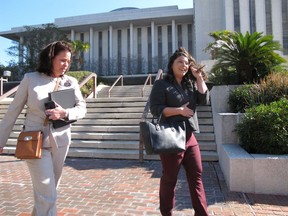 In a Tuesday, Jan. 30, 2018 photo, Leslie Dangerfield, left, whose husband was a firefighter who took his own life, and Jessica Realin, whose husband is now disabled after PTSD brought on by the Pulse nightclub massacre, leave the Florida Capitol after testifying for a bill that would extend workers compensation benefits to first responders who suffer from PTSD, in Tallahassee, Florida.