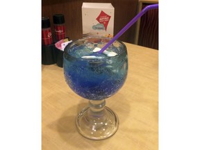 In this Tuesday, Feb. 13, 2018 photo, a blue raspberry soda topped with gummy candies awaits a sip at a Concord, N.H., restaurant. The New Hampshire Legislature is considering a bill aimed at prohibiting restaurants from offering such sugary drinks with children's meals. The bill, which had a public hearing Wednesday, Feb. 14, 2018,, would restrict beverage choices for children's meals that bundle food and drink to milk, 100 percent juice, juice combined with water, plain water or flavored water with no sweeteners.
