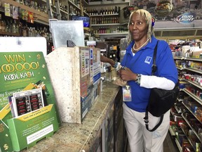 San Francisco Goodwill store employee Debra Shaw, shops inside Frank's liquor store on Haight Street in San Francisco Thursday, Feb. 22, 2018. Shaw said she was saddened and horrified by the news that three men were found dead outside a private high school in the Haight-Ashbury neighborhood. She says she walks by the school all the time and knows that drugs are a problem.