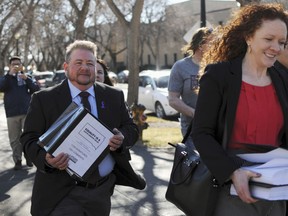 FILE - In this Feb. 23, 2016, file photo, Terri Bruce, left, walks toward the state Capitol in Pierre, S.D. Bruce said a new South Dakota bill to ban public school teaching on gender identity in elementary and middle schools would have unintended consequences and send a message to transgender children that "they are somehow not human."