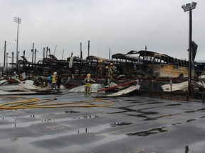 Firefighters clear wreckage from a school bus depot in South Whitehall, Pa.,, that was destroyed by fire ion Friday, Feb. 23, 2018.   Jeff Johnson, chief of the Tri-Clover Fire Co., said 16 buses inside the building were destroyed, and a dozen outside the building received damage that ranged from blistered paint to broken windshields. The 25 destroyed or damaged buses represent about 25 percent of the district's fleet. No injuries were reported, and the cause of the fire remained under investigation.