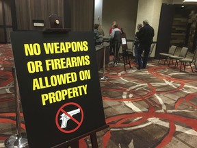 A sign prohibiting any firearms at the Nugget hotel-casino greets members of the Independent American Party of Nevada as they enter the party's state convention where southern Nevada rancher Cliven Bundy gave the keynote address Friday, Feb. 23, 2018 in Sparks, Nev.