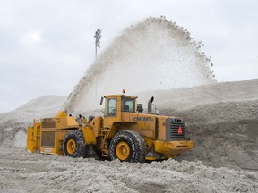A snowblower piles snow at the city's newest dump at Blue Bonnets as snow removal operations continue Wednesday, February 14, 2018 in Montreal.