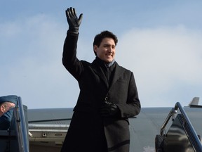 Prime Minister Justin Trudeau waves as arrives in Chicago, on Wednesday, February 7, 2018.
