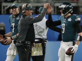 Philadelphia Eagles quarterback Nick Foles (9) celebrates a touchdown with head coach Doug Pederson, during the first half of the NFL Super Bowl 52 football game against the New England Patriots, Sunday, Feb. 4, 2018, in Minneapolis.