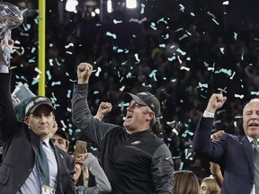 Philadelphia Eagles general manager Howie Roseman, left, holds up the Vince Lombardi Trophy as he celebrates with head coach Doug Pederson, center, and owner Jeffrey Lurie after the NFL Super Bowl 52 football game against the New England Patriots, Sunday, Feb. 4, 2018, in Minneapolis. The Eagles won 41-33.