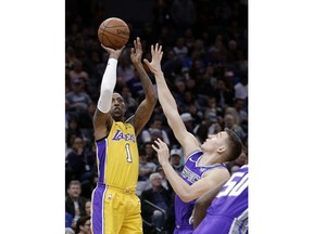Los Angeles Lakers guard Kentavious Caldwell-Pope, left, shoots over Sacramento Kings guard Bogdan Bogdanovic during the first quarter of an NBA basketball game Saturday, Feb. 24, 2018, in Sacramento, Calif.