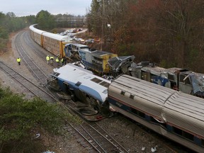 Authorities investigate the scene of a fatal Amtrak train crash in Cayce, South Carolina, Sunday, Feb. 4, 2018. At least two were killed and dozens injured.