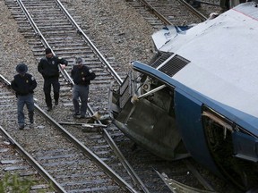 Authorities investigate the scene of a fatal Amtrak train crash in Cayce, South Carolina, Sunday, Feb. 4, 2018. At least two were killed and dozens injured.