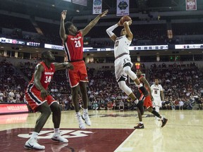 South Carolina forward Justin Minaya (10) takes a jump shot over Georgia forwards Rayshaun Hammonds (20) and Derek Ogbeide (34) during an NCAA college basketball game Wednesday, Feb. 21, 2018, in Columbia, S.C.