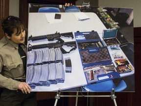 Los Angeles County Sheriff Deputy Lisa Jansen sets up a picture on Wednesday, Feb. 21, 2018, showing AR-15 type weapons and ammunition found at a student's home after he threatened a school shooting at El Camino High School in Whittier.