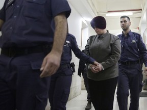 Australian Malka Leifer is brought to a courtroom in Jerusalem, Tuesday, Feb. 27, 2018. An Israeli court says Leifer who is accused of sex crimes will not be extradited for reasons of mental illness.