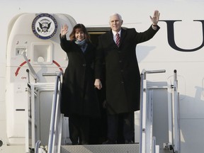 U.S. Vice President Mike Pence and his wife Karen Pence wave upon their arrival at Osan Air Base in Pyeongtaek, South Korea, Thursday, Feb. 8, 2018.