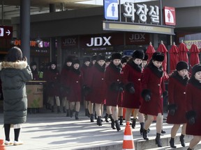 North Korean cheering squads leave an expressway service in Gapyeong, South Korea, Wednesday, Feb. 7, 2018. A North Korean delegation, including members of a state-trained cheering group, arrived in South Korea on Wednesday for the Pyeongchang Winter Olympics.