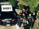 A man (in dark red) believed to be Nikolas Cruz Law is arrested following a shooting at Marjory Stoneman Douglas High School in Parkland, Fla., Wednesday, Feb. 14, 2018.