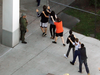 Students are brought out of the Marjory Stoneman Douglas High School after a shooting that killed 17 people on Feb. 14, 2018 in Parkland, Florida.