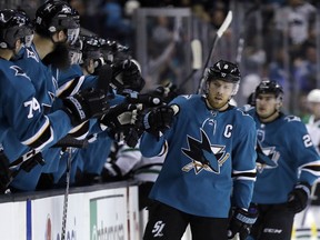 San Jose Sharks center Joe Pavelski, right, celebrates his goal with teammates during the first period of an NHL hockey game Sunday, Feb. 18, 2018, in San Jose, Calif.