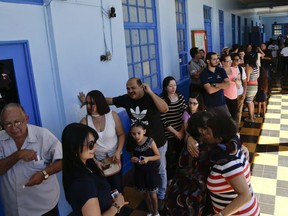 Voters are seen at a polling station during presidential election in San Jose, Costa Rica, Sunday, Feb. 4, 2018. Costa Rica will hold general elections on Sunday, Feb. 4. Costa Ricans voted Sunday in a presidential race shaken by an international court ruling saying the country should let same-sex couples get married.
