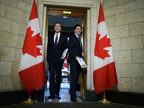 Minister of Finance Bill Morneau walks with Prime Minister Justin Trudeau as they leave his office on route to deliver the federal budget in the House of Commons on Parliament Hill in Ottawa on Tuesday, Feb. 27, 2018.
