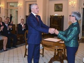 Newly-elected Nationals party leader Michael McCormack, left, is congratulated by the Administrator of the Government of the Commonwealth of Australia, Linda Dessau, after being sworn-in as the deputy prime minister during a ceremony at Government House in Canberra, Monday, Feb. 26, 2018. McCormack has been appointed after his predecessor quit over a sexual harassment allegation.