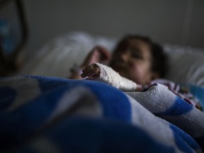 Sarah Mishan, a three-year-old Syrian refugee, lies in a hospital bed at the Bekaa hospital in Lebanon on Jan. 25 after being rescued on the mountains separating Syria from Lebanon.