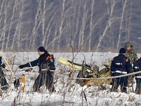Personnel work at the scene of the AN-148 plane crash in Stepanovskoye village, about 40 kilometers (25 miles) from the Domodedovo airport, Russia, Moday, Feb. 12, 2018. The Russian passenger plane carrying 71 people crashed Sunday near Moscow, killing everyone aboard shortly after the jet took off from one of the city's airports. The Saratov Airlines regional jet disappeared from radar screens a few minutes after departing from Domodedovo Airport en route to Orsk, a city some 1,500 kilometers (1,000 miles) southeast of Moscow.
