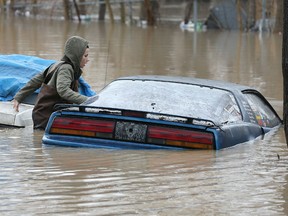 Amber Hawkins checks out a car parked in the rear of a downtown Chatham, ON. home along the Thames River on Friday, February 23, 2018. (DAN JANISSE/The Windsor Star