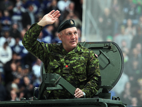 Former Toronto Maple Leaf Dave "Tiger" Williams salutes the crowd on military honour night before a game in Toronto on March 16, 2013.